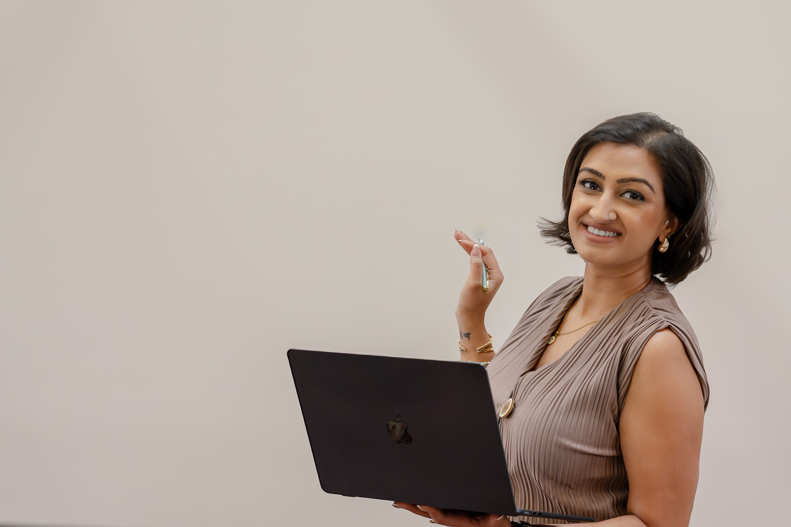Female wellness coach holding a laptop during an online session